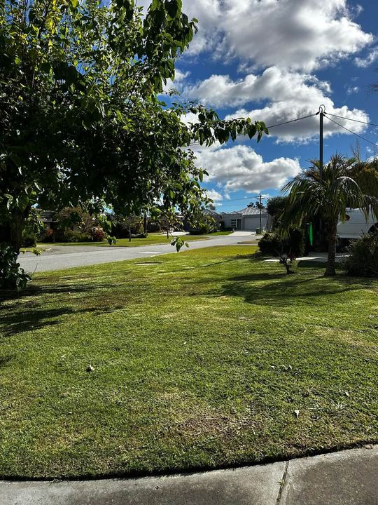 Neatly mowed corner-block lawn with crisp edges